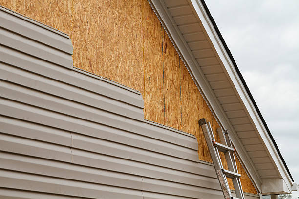 Professional Storm Damage Siding Repair technician working in Barberton, OH
